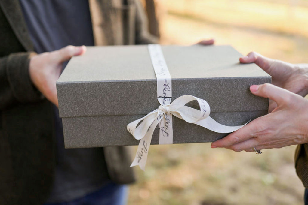 The Peony Story Root Gift in hands of two people